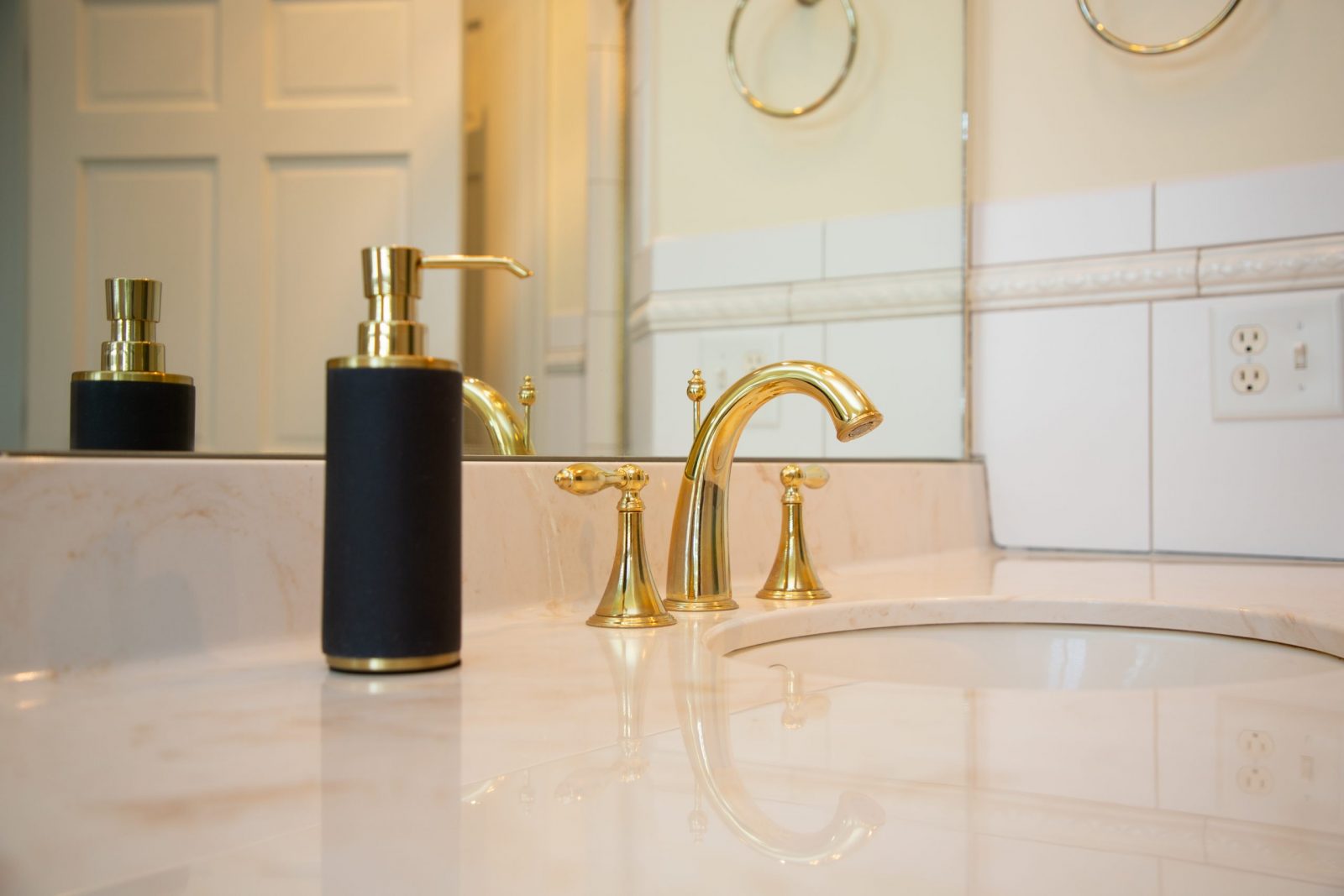 Gold sink fixtures and light marble counter